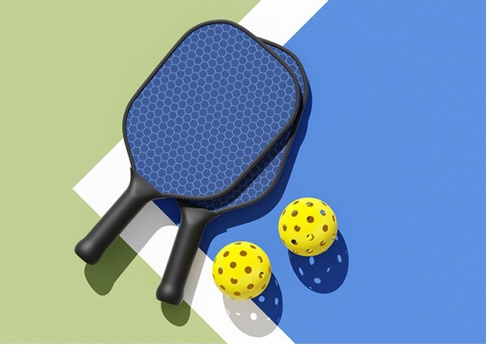 Pickleball rackets and balls on court